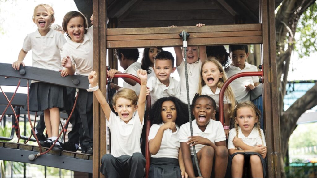 Happy children playing on a playground at a South Florida private school, showing a joyful school community.