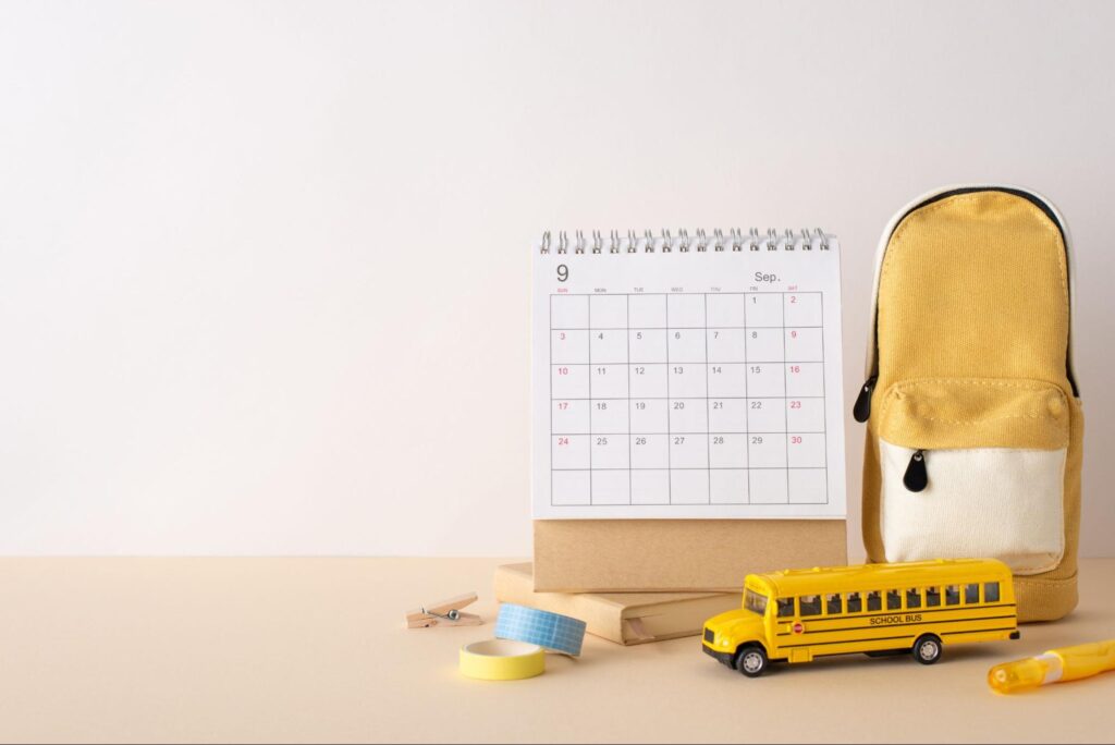 Florida school calendar with school bus and backpack showing early August start dates.