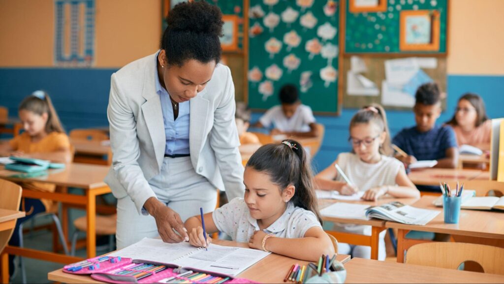 Florida elementary school teacher helping a student during class