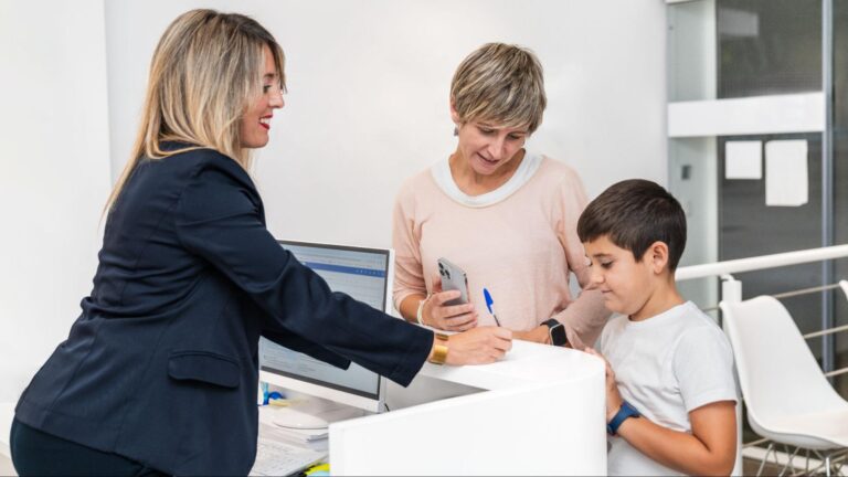 Parent and child completing registration at a Florida school office.