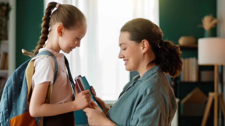 Parent handing books to a child with a backpack before school., representing Florida school legal and policy requirements for families moving from another state or country.