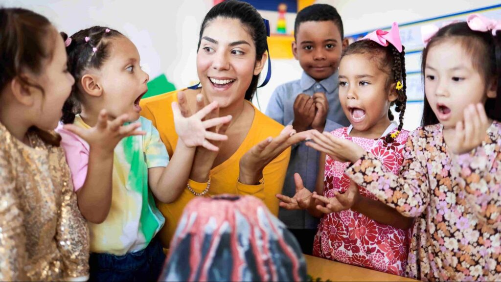 Teacher and young children in a Miami Pre-K classroom reacting excitedly to a hands-on science activity, supporting early childhood education and engagement.