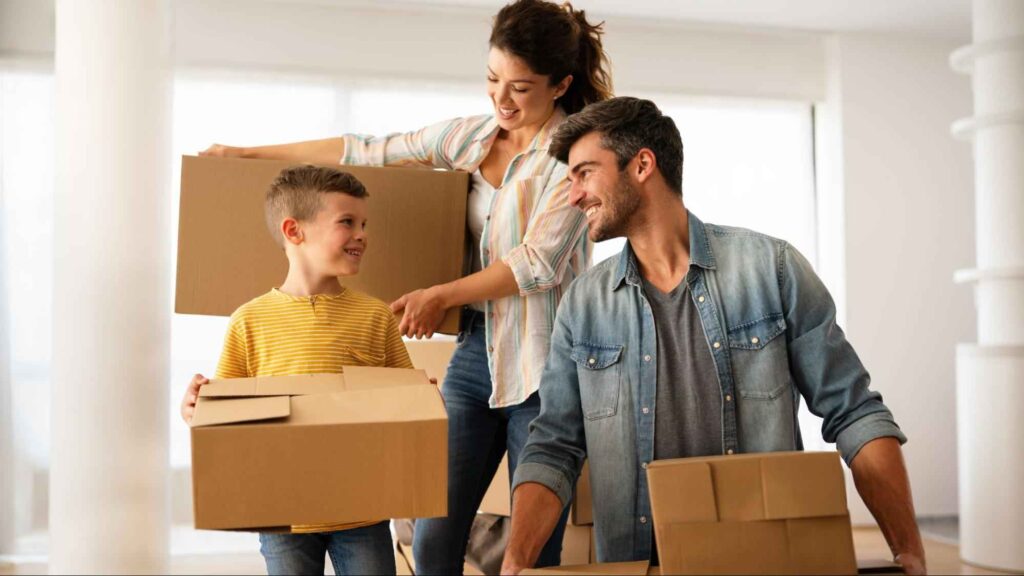 Family unpacking boxes and smiling after moving to a new home in Miami.