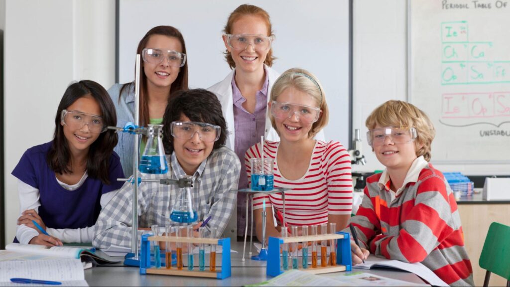 Middle school students in Miami participating in a science lab with a teacher, exploring STEM activities and hands-on learning