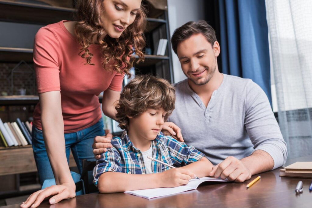 Parents helping their child with schoolwork while preparing for Miami private school admissions.