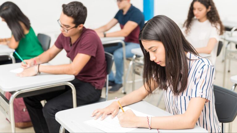 A group of focused students taking a standardized entrance exam for Miami private school admissions.